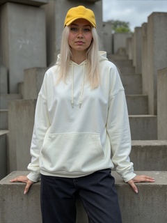 yellow baseball cap, white hoodie, and black joggers, abstract concrete background