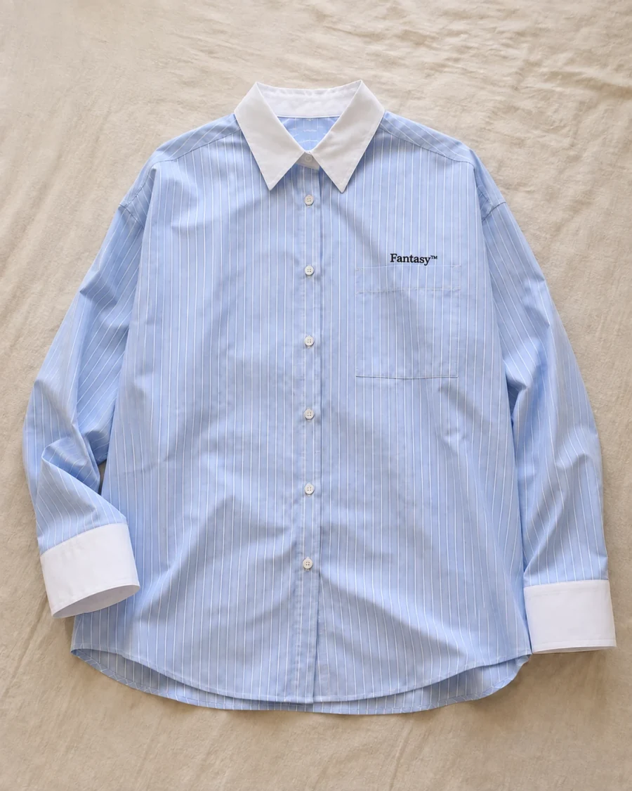 Casual flat-lay reference of a blue Fantasy pinstripe shirt
